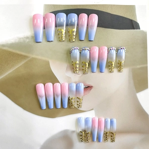 Long coffin press-on nails with pink-blue gradient, gold sequins, and rhinestones