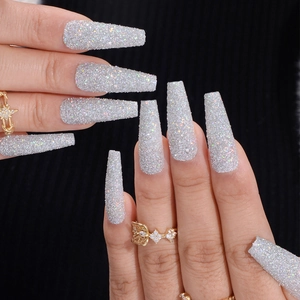 Silver holographic glitter long coffin press-on nails shown on hand against dark background
