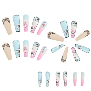 Long coffin press-on nails with blue-pink gradient, floral patterns, and rhinestone accents