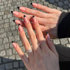 Classic French almond press-on nails with nude base and black glitter tips for women