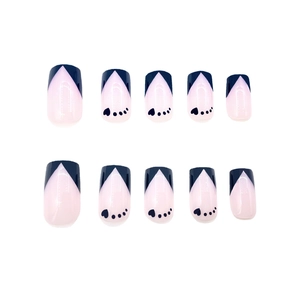 Detailed flat lay of medium square blue French V-tip press-on nails with heart accents