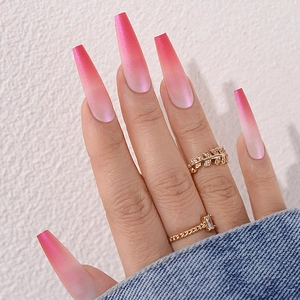 Close-up of long ballerina press-on nails with pink to white ombre and pearlescent shimmer