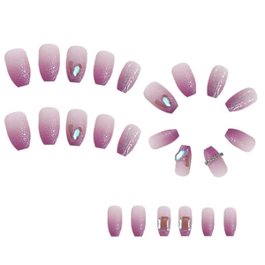 Macro detail of gradient purple glitter press-on nails with rhinestone accents