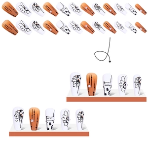 Faux ongles mats à presser orange et blanc avec perles et lignes abstraites noires