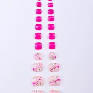 Flat lay of pink press-on toe nails with marble patterns and glitter finishes