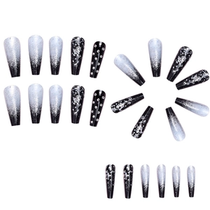 Long coffin fake nails featuring black glitter gradient and sparkling rhinestones