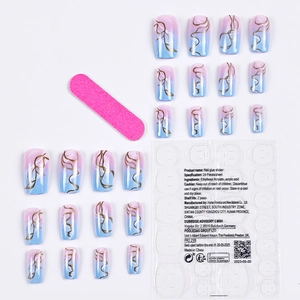 Pink and blue gradient press-on nails set with gold marble swirls and manicure tools
