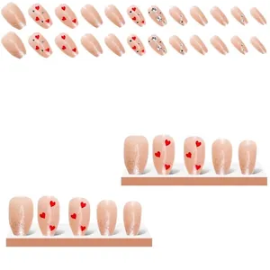 Press-on nail kit with nude glitter gradients, red heart patterns and rhinestone accents