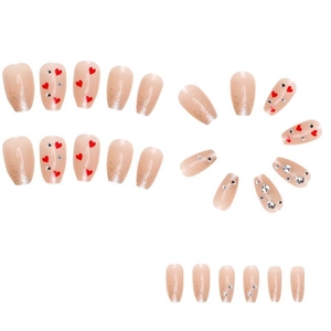 Sparkly heart press-on nails with pink gradient and rhinestones in medium oval shape
