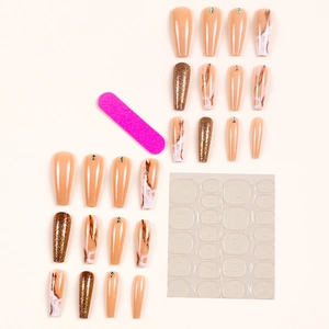 Long coffin press-on nails with marble patterns, glitter, and rhinestones in nude pink