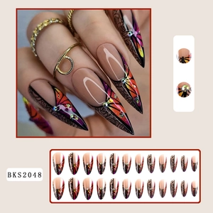French almond press-on nails with rose designs, butterfly patterns, and rhinestones