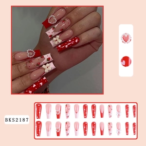 Long coffin press-on nails with strawberry heart designs and 3D bow pearl charms