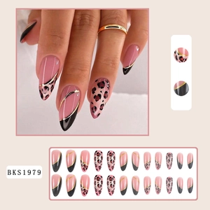 Macro detail of almond press-on nails featuring pink leopard patterns and gold line accents