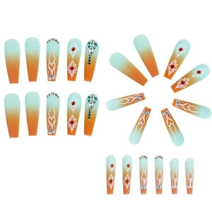Long coffin press-on nails with green-orange gradient, floral art, and 3D rhinestones