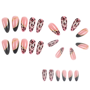 Detailed view of pink almond press-on nails with leopard print and black gold tips