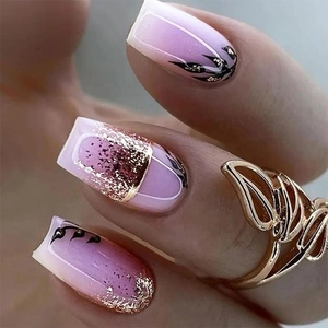 Purple gradient press-on nails with gold glitter and black leaf motifs in medium square shape