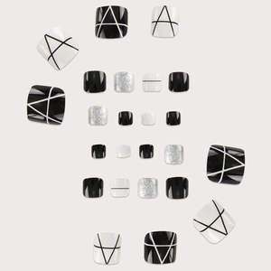 Glossy silver, black and white press-on toenails with geometric patterns and glitter finish