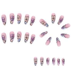 Pink matte almond press-on nails with floral patterns, French gradient, and tiny rhinestones