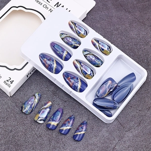 Detailed view of blue amber marble press-on nails with gold foil in gift box packaging