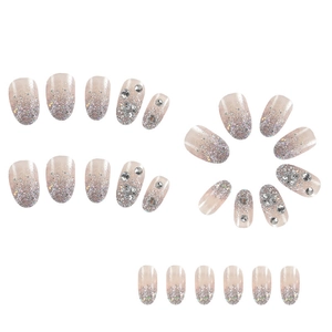 Macro shot of 24 pieces short almond press-on nails with silver glitter and rhinestones