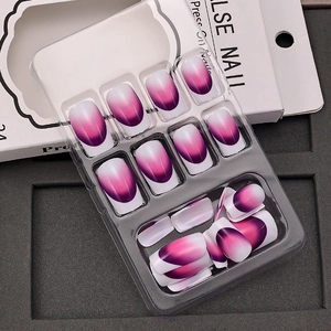 Macro view of purple gradient press on nails in transparent tray with packaging box