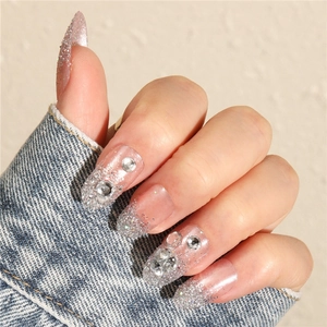 Pink nude almond press-on nails with silver glitter gradient and 3D rhinestones