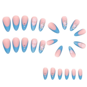 Macro view of matte almond press-on nails with 3D white rose reliefs and crystal details