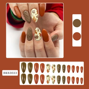 Autumn almond press-on nails with maple leaf art and 3D sweater texture design