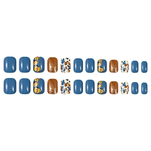 Short square press-on nails with blue matte finish, gold glitter, and leaf patterns