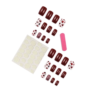 Glossy burgundy and red heart pattern press-on nails set with tools on white background