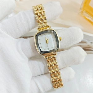 Detailed close-up of a women's luxury square gold watch with diamond markers