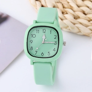 Minimalist mint green quartz watch with silicone strap and square dial on white background