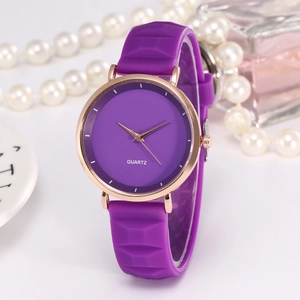 Detail of purple quartz watch with silicone strap and elegant rose gold metal casing
