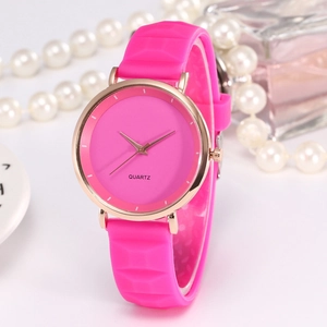 Detail of rose pink silicone watch with geometric texture and gold metal case