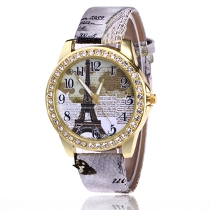 Detail of Eiffel Tower watch face with rhinestones and vintage butterfly print strap