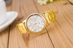 Detailed close-up of Geneva gold steel men's watch with white dial and Roman numerals