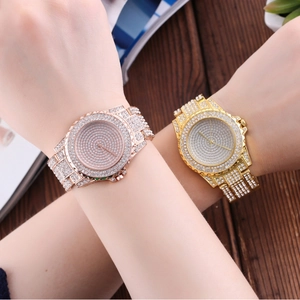 Detailed close-up of luxury full rhinestone quartz watches in rose gold and gold finishes