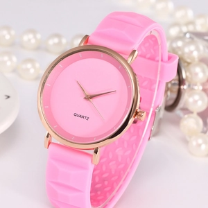 Pink silicone quartz watch with rose gold case and textured strap on elegant background