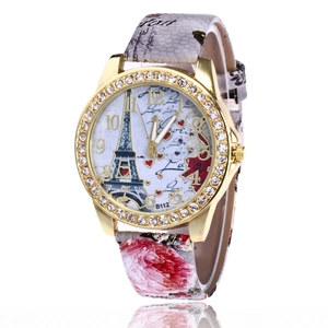 Detail of Eiffel Tower and rose dial with sparkling rhinestones on gold watch