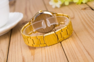 Detailed back view of gold stainless steel watch strap and polished silver case back