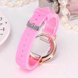 Pink silicone strap and rose gold case watch styled with pearls and perfume accessories