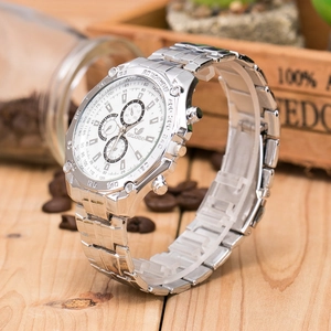 Detail of silver stainless steel business watch with three sub-dials on white face