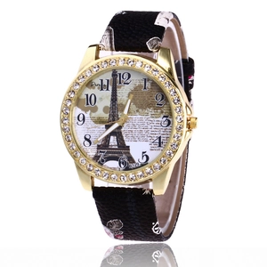 Golden Eiffel Tower watch for women with rhinestone bezel and black textured strap