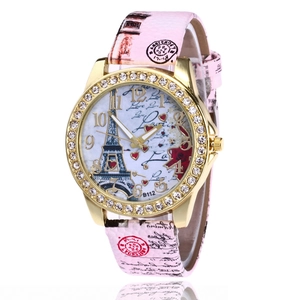 Detailed view of pink leather strap watch with Eiffel Tower dial and rhinestone bezel