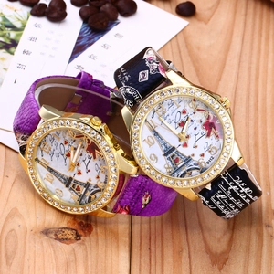 Close-up of Eiffel Tower dial watches with rhinestones and vintage texture
