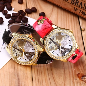 Close-up of vintage quartz watches with Eiffel Tower dial and floral leather straps