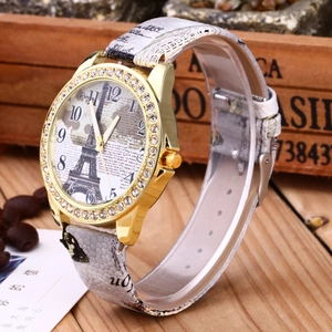 Close-up of vintage lady watch with Eiffel Tower dial and rhinestone gold bezel