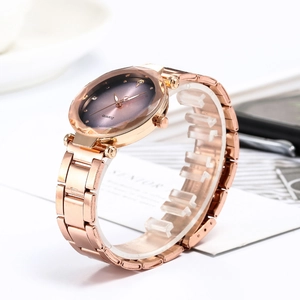 Macro detail of rose gold quartz watch with purple gradient dial and diamond markers