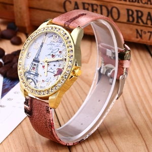 Close-up of vintage gold watch with rhinestone bezel on rustic wooden background
