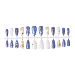 Blue and white handmade press-on nails with pearls, 3D bows, and golden star patterns